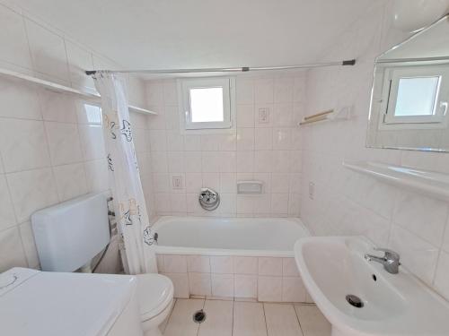 a bathroom with a tub and a toilet and a sink at Beach House Kotrona in Achladi