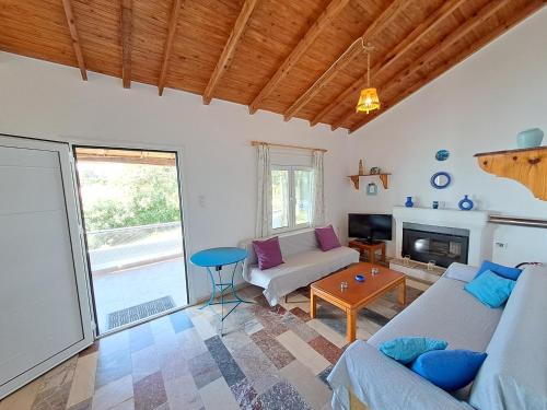 a living room with a couch and a table at Beach House Kotrona in Achladi