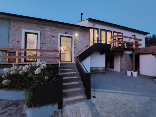 a brick building with a staircase leading to a house at Casa Bem Estar in Mortágua