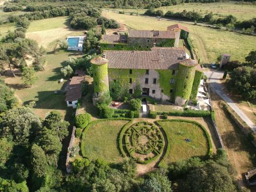 an aerial view of an estate with a clock in the yard at Château de Villarlong in Villarzel-Cabardès