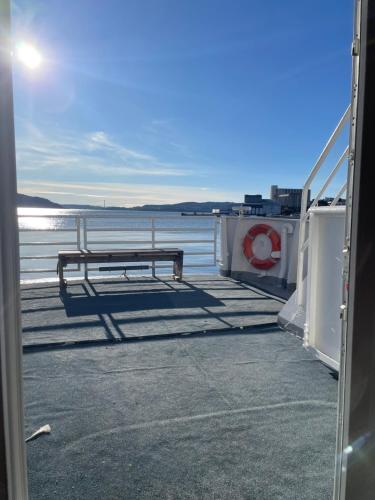 a bench sitting on a dock near the water at Showboat in Bergen