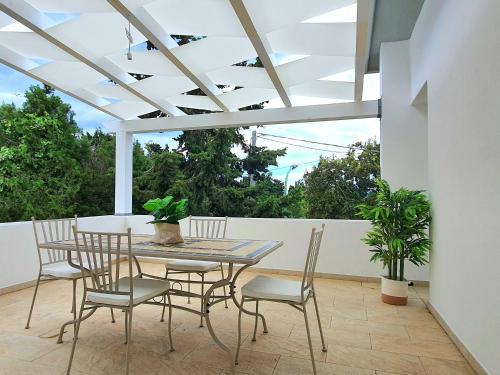 a table and chairs on a patio with a ceiling at Marinaway - Appartamenti a 2 chilometri dal mare in Orosei