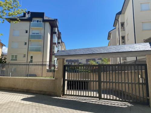 a gate with a fence in front of a building at Apartamento Libertad in Jaca
