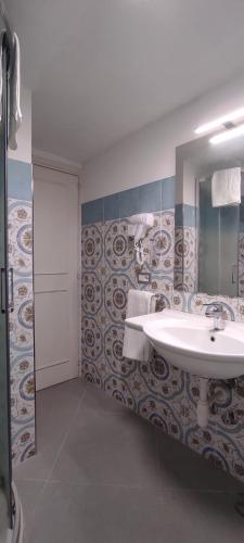 a bathroom with a sink and a mirror at La Romantique in Anacapri