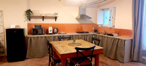 a kitchen with a table and a kitchen with a stove at Spartivento Apartments in Matera