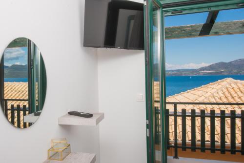 a room with a mirror and a view of the ocean at Amelia Villa in Nikiana