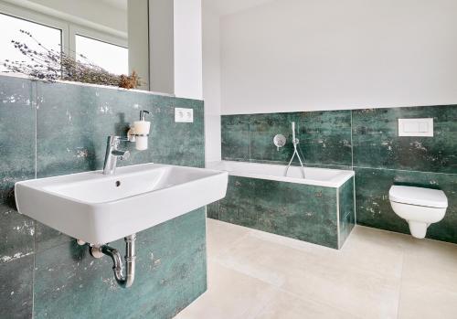 a bathroom with a sink and a toilet at Bei Meyers - Zwenkauer See in Zwenkau