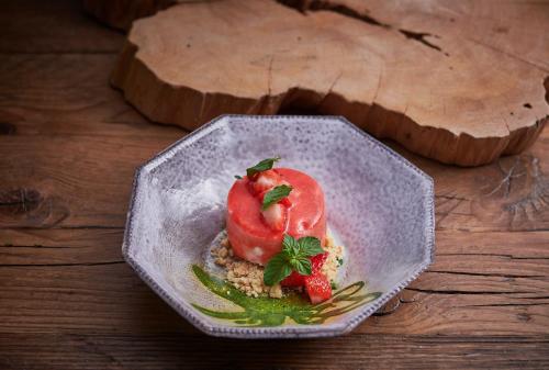 a plate of food with strawberries on a table at Cascioni Eco Retreat in Arzachena