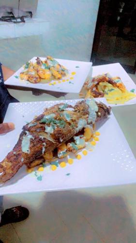 two plates of food sitting on top of a table at Hotel le Trarza in Niaga