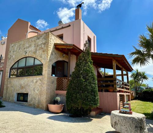 a house with a tree in front of it at Seaview Villa Liandroy in Sellía