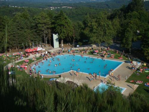 a group of people in a large swimming pool at Casa "Pinho" com Jacúzi! in São Pedro do Sul