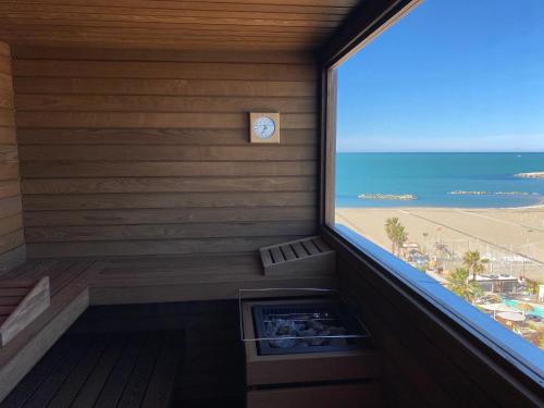a room with a window with a view of the beach at Park Hotel Cattolica & Restaurant in Cattolica