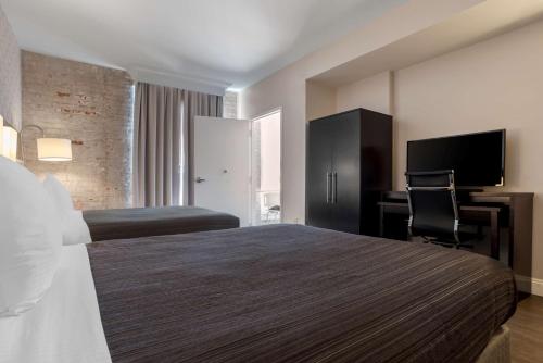 a hotel room with a bed and a desk at Best Western Plus St. Christopher Hotel in New Orleans