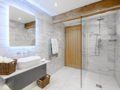 a bathroom with a sink and a shower at Admergill Lodge in Barrowford