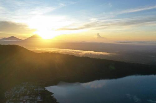 a view of the sun setting over a lake at Villa Jado 3 - Lake and Mountain View Villa in Bedugul