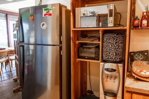 a kitchen with a stainless steel refrigerator in a kitchen at Villa Jado 3 - Lake and Mountain View Villa in Bedugul