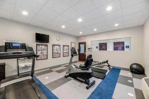 a gym with a treadmill and a chair in a room at Comfort Inn & Suites in Andrews