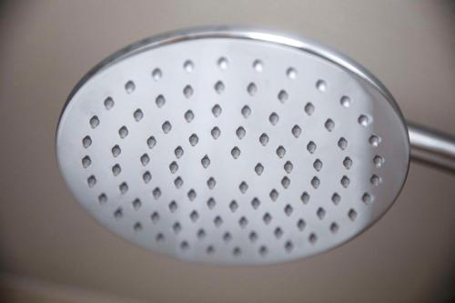 a metal shower head with holes in it at Nightcap at Empire Hotel in Gepps Cross