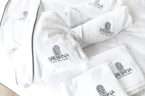 a pile of white napkins on a table at Srebrna Luxury Apartments - willa fabrykancka - wnętrza premium in Łódź