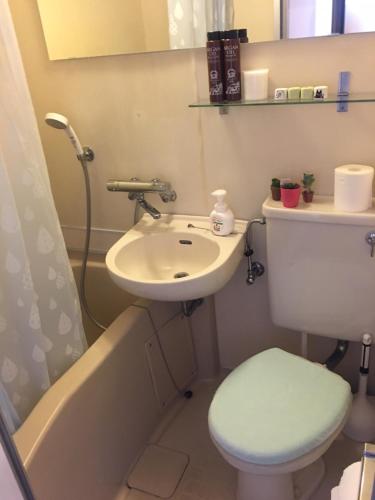 a bathroom with a sink and a toilet and a bath tub at 10 minutes direct to Shibuya Crossing! Heart of Tokyo! Mishuku in Tokyo