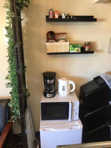 a microwave oven sitting on top of a refrigerator at 10 minutes direct to Shibuya Crossing! Heart of Tokyo! Mishuku in Tokyo