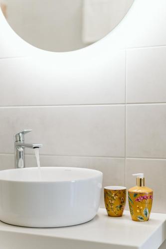 a bathroom with a sink and two vases on a counter at Villa Limnes in Perissa