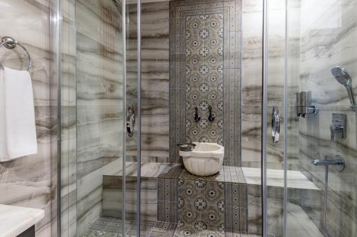 a bathroom with a shower with a glass door at Baymari Suites Design Florya in Istanbul