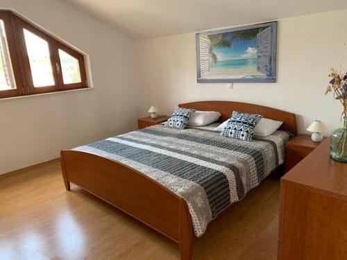 a bedroom with a bed and two windows at Francis Appartements in Pakoštane