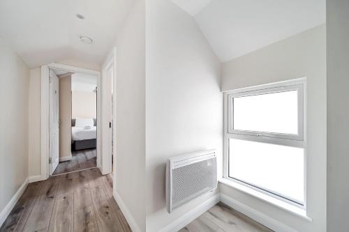 a white room with a window and a radiator at Carlisle Lodge 'Sleeping 6 guests' in Derry Londonderry