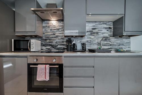 a kitchen with white cabinets and a counter top at Carlisle Lodge 'Sleeping 6 guests' in Derry Londonderry