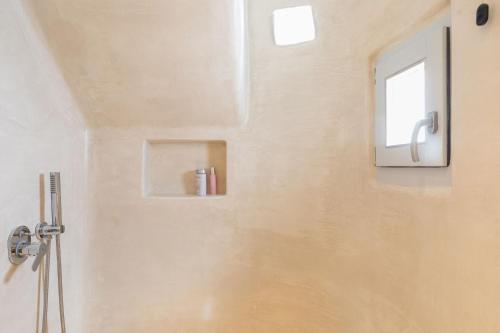 a bathroom with a shower with a window at Elena Hotel Mykonos in Mýkonos City
