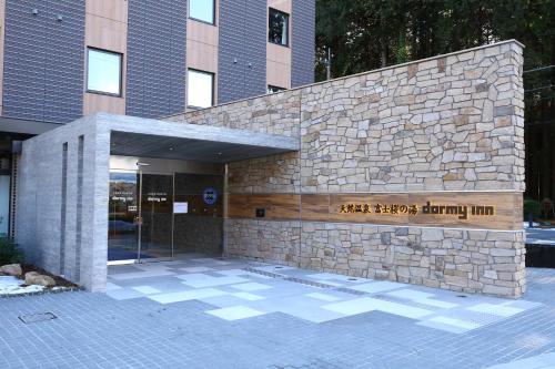 a building with a sign on the side of it at Dormy Inn Express Fujisan Gotemba in Gotemba