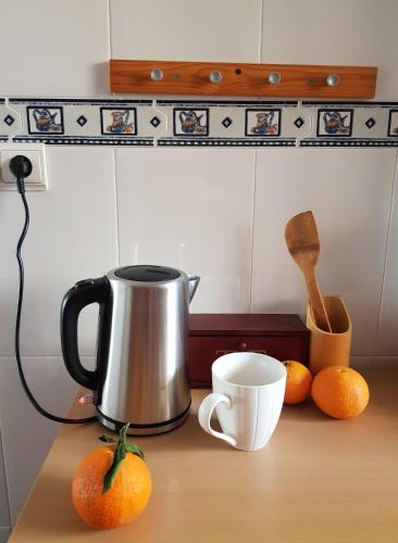 a coffee pot and some oranges on a table at Cabo de Palos Apartment in Cabo de Palos