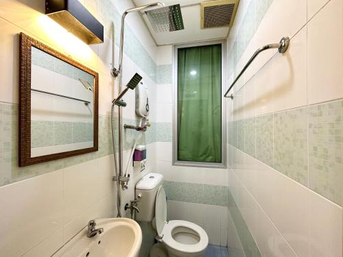 a bathroom with a sink toilet and a window at Hotel Tourist City Centre by HotSpot Essential in Kota Kinabalu