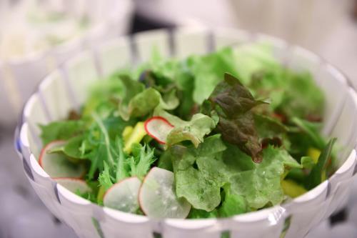 a salad in a white bowl with lettuce and apples at Dormy Inn Express Fujisan Gotemba in Gotemba