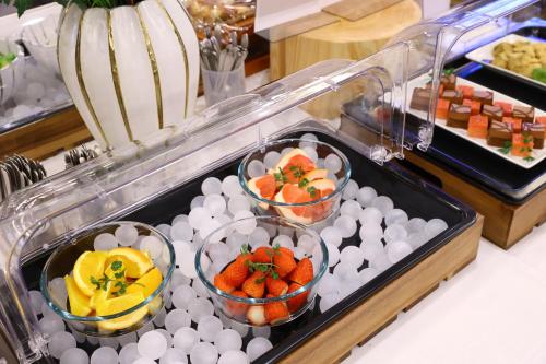 a buffet with strawberries and fruit in bowls and eggs at Dormy Inn Express Fujisan Gotemba in Gotemba