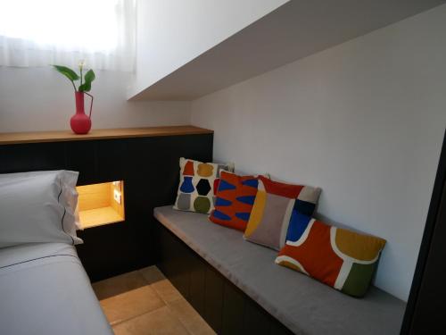 a room with a bench with pillows and a window at La Rayuela in Monachil