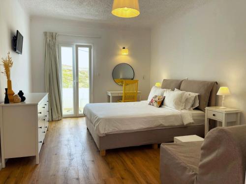 a bedroom with a bed and a living room at Adonis Hotel Studios & Apartments in Naousa
