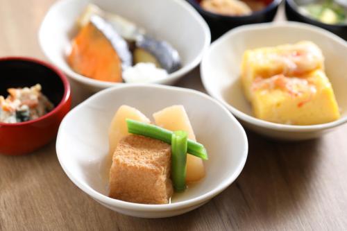 a group of bowls filled with different types of food at Dormy Inn Express Fujisan Gotemba in Gotemba