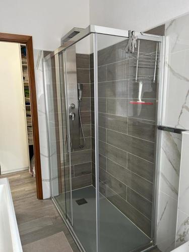 a shower in a bathroom with a glass door at Best Way Rent - Casa Ida in Lavagna