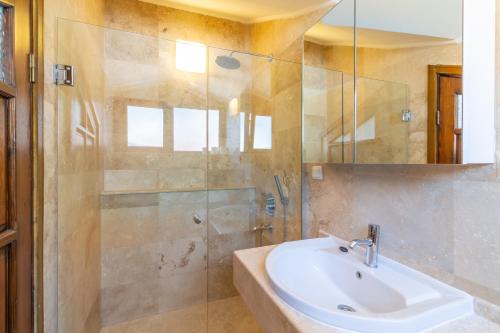 a bathroom with a sink and a shower at Korsan Apartment No.12 in Kaş