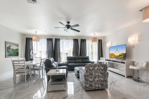 a living room with a couch and a tv at Breathtaking Condos Near French Quarter in New Orleans