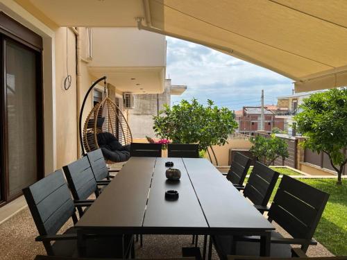 a table and chairs on the balcony of a house at Artline Family Suite in Flogita