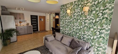 a living room with a couch and a kitchen at Jaukūs apartamentai Free parking in Vilnius
