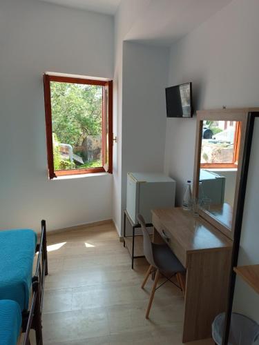 a room with a desk and a table and a window at Imeros in Chania Town