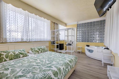 代森扎諾－德爾加達的住宿－HOTEL Villa Lilla，一间卧室配有一张床、一个浴缸和一个浴缸