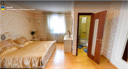 a bedroom with a large bed and a bathroom at Готель Поділля in Shestakovka