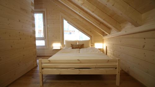 a bedroom in a log cabin with a bed in it at aeki BLOCK in Imst