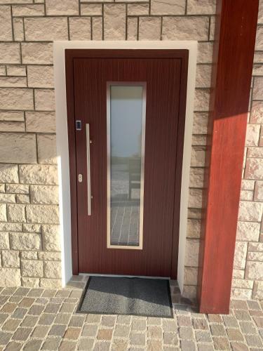 a wooden door in a brick building at Žigon Bed & Breakfast in Logatec