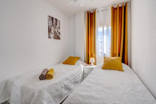 a bedroom with two beds and a window at BuenaVista Palmeras in Costa Adeje in Adeje